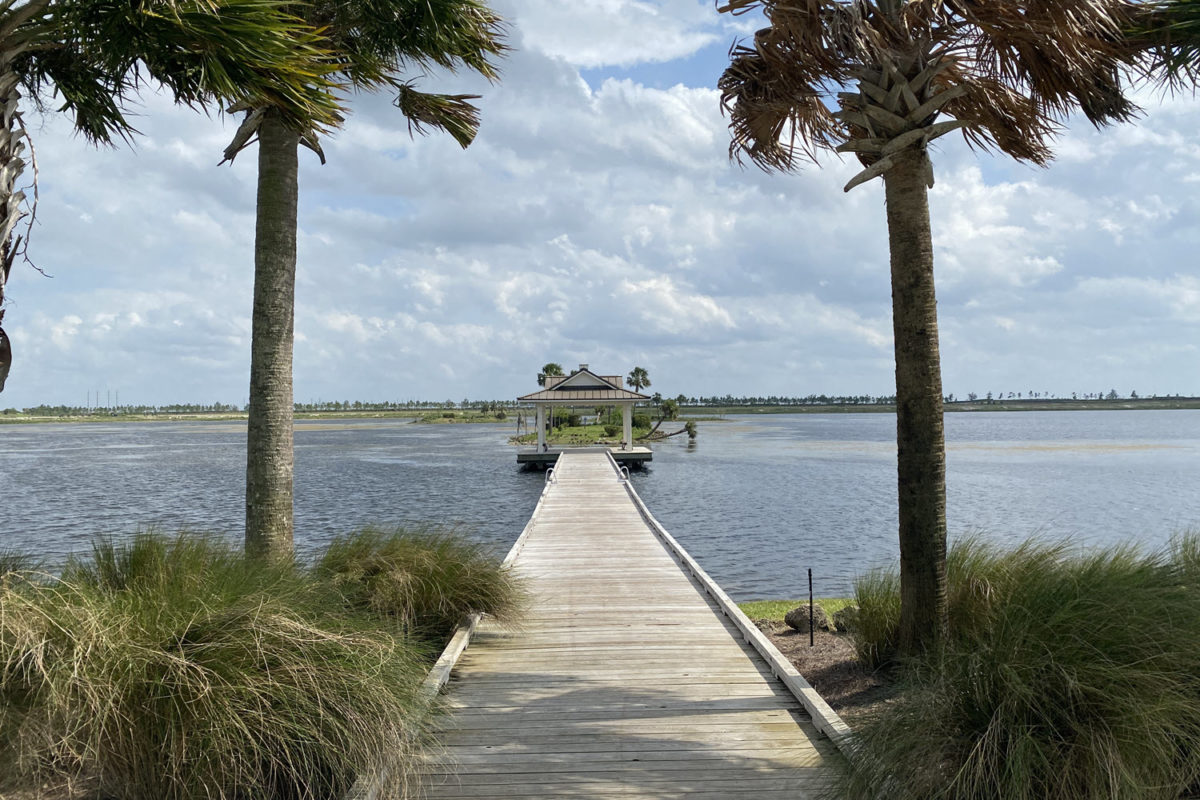walkway out to the pier overlooking lake at arden loxahatchee florida