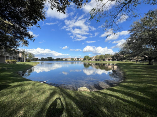 Stunning view of lake behind the villas of rolling hills townhomes in davie fl