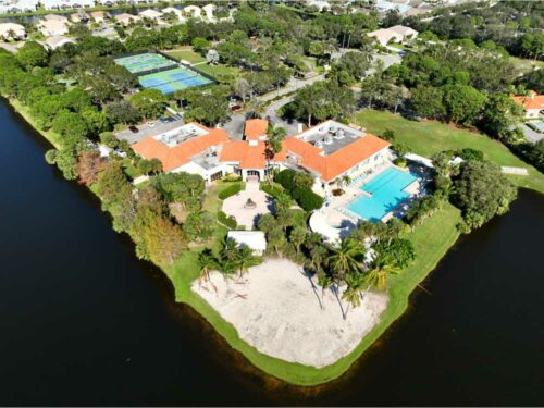 View overlooking the Kings Isle Clubhouse and Pool with Tennis Courts In Background of St Lucie West