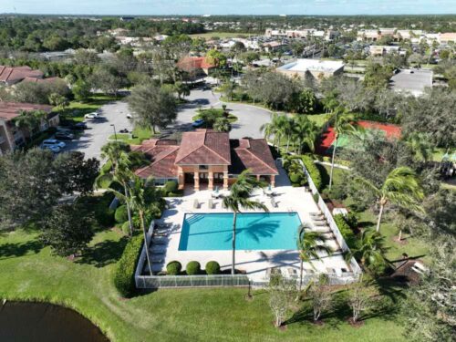 Aerial view of the Clubhouse and Community Pool located in The Club Condominium community in St Lucie West